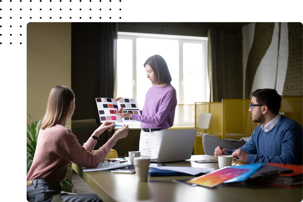 Creative team reviewing brand color swatches during a graphic design meeting at Buildleads Solutions