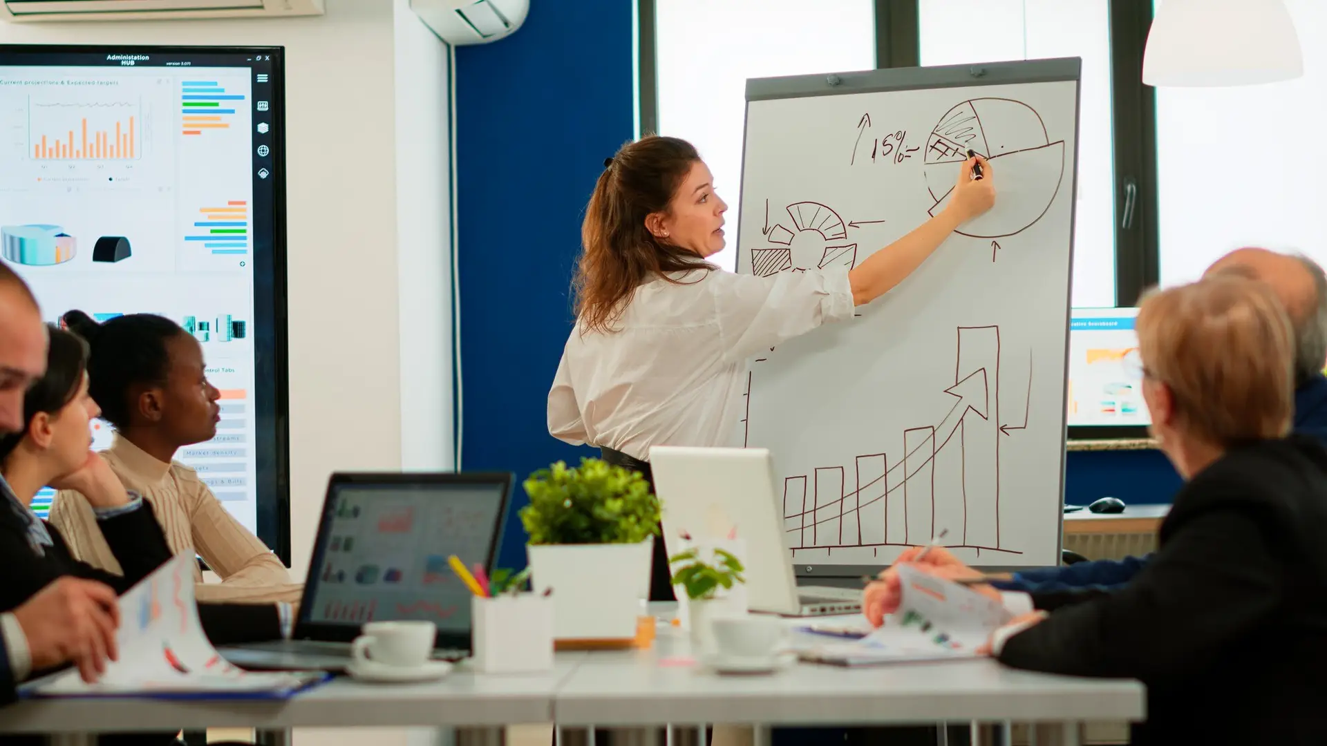 Marketing expert presenting a business growth strategy on whiteboard